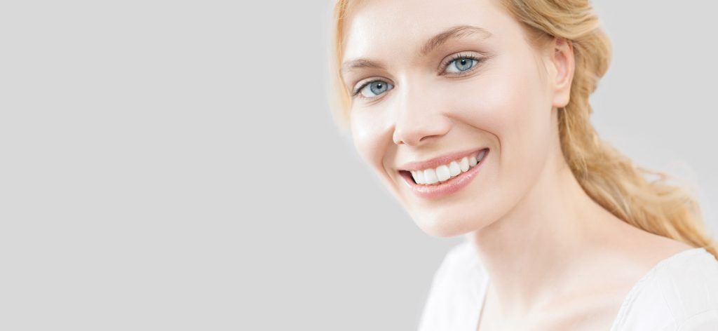 Blue eyed girl on a gray background