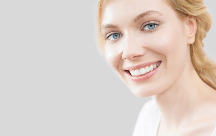 Blue eyed girl on a gray background