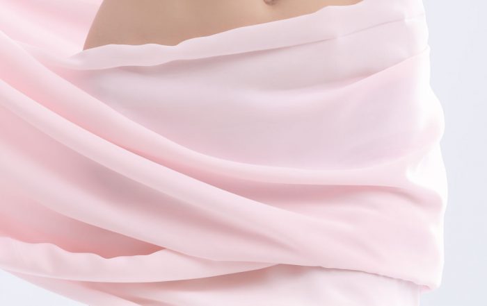 youn woman covered in a pink towel